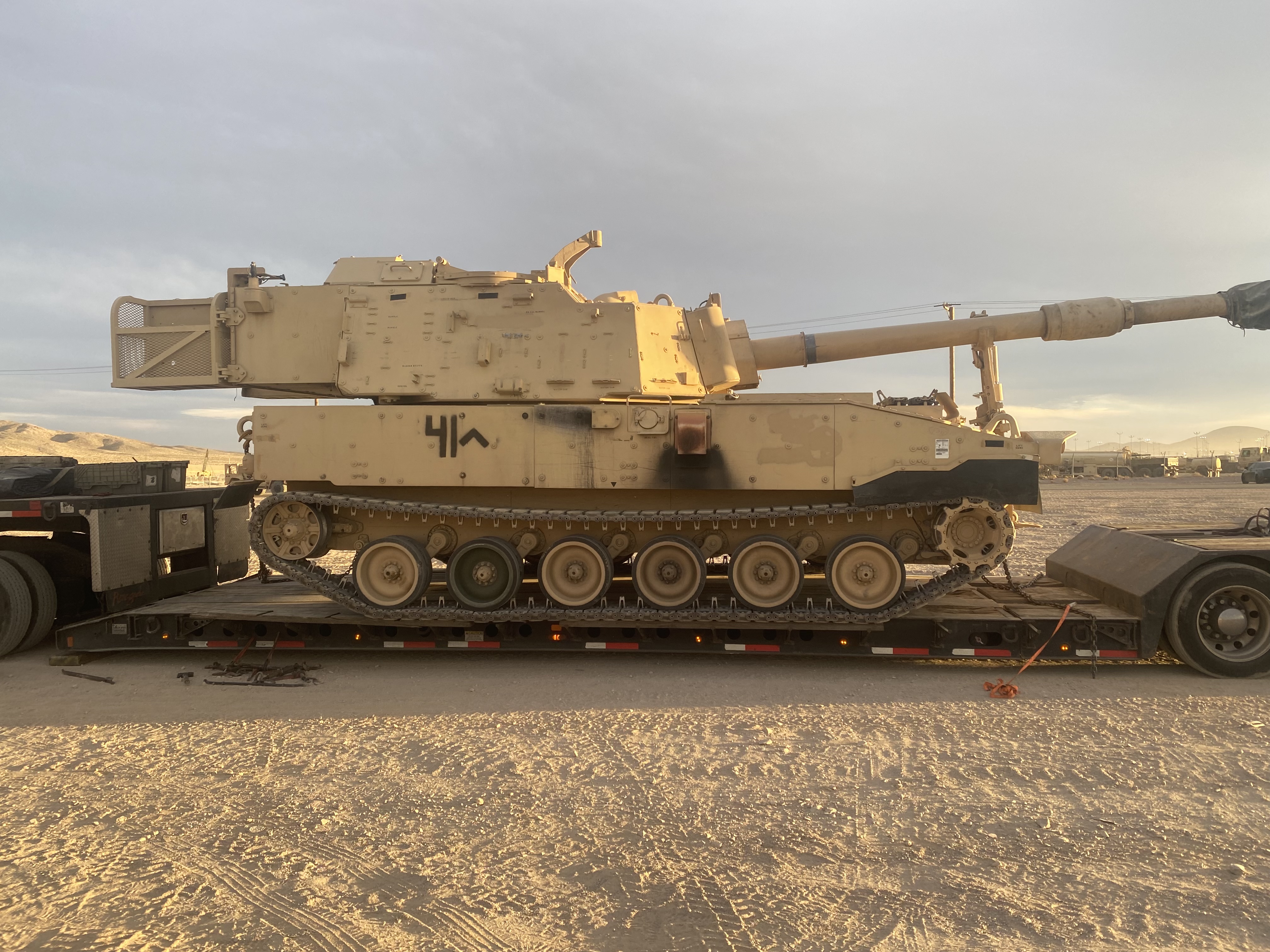 Military self-propelled howitzer on a heavy haul trailer